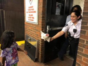 Photo of one of our members returning a lost toy to a little girl.